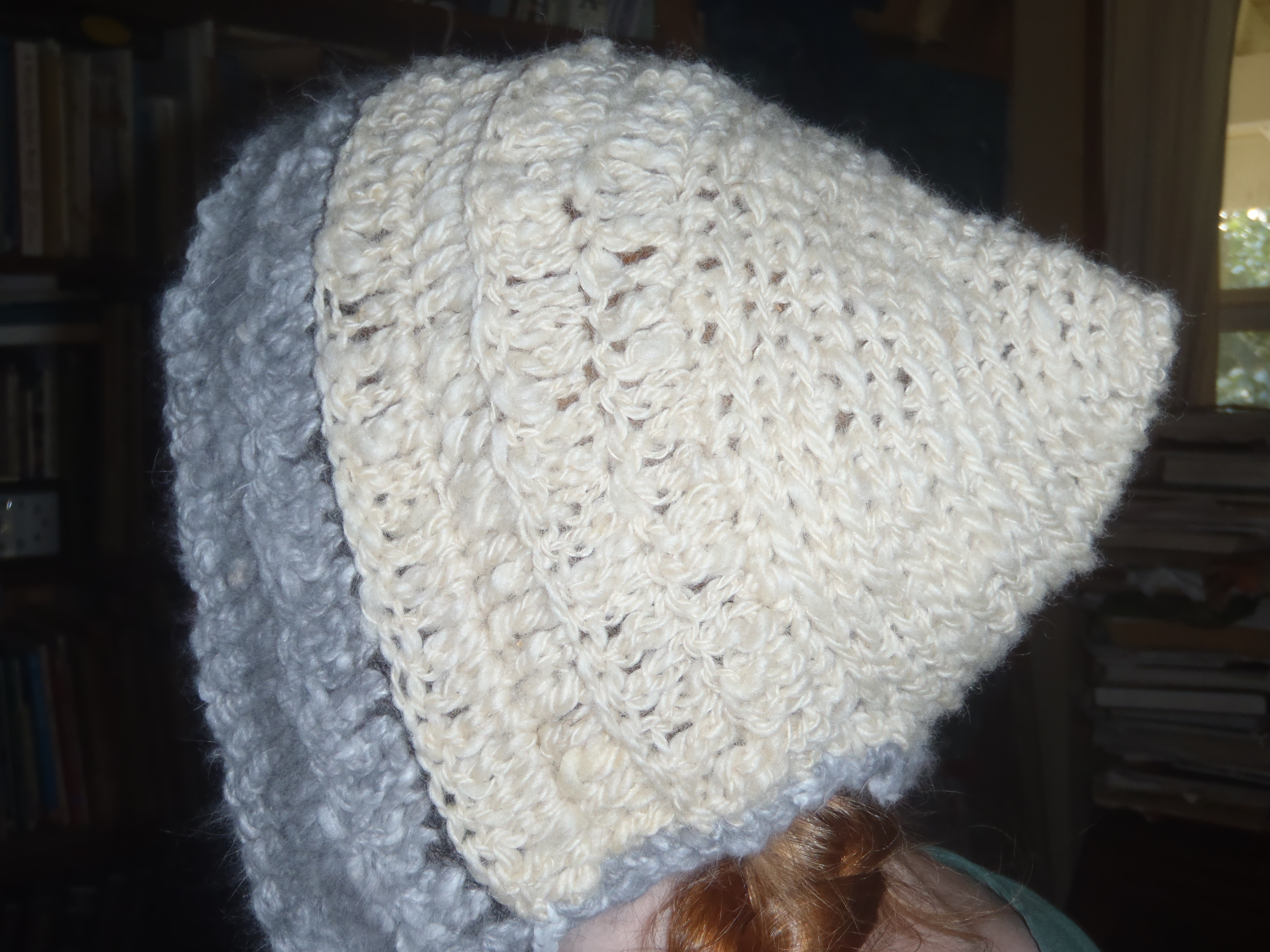 Hand crocheted sheep wool hat with angora trim.