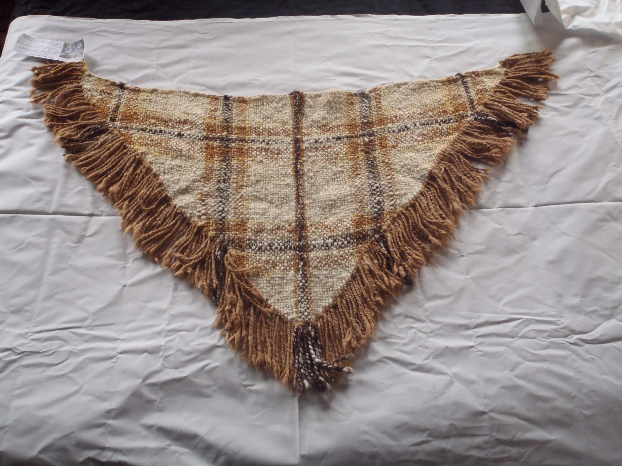 Photo of the shawl with alpaca fringe.