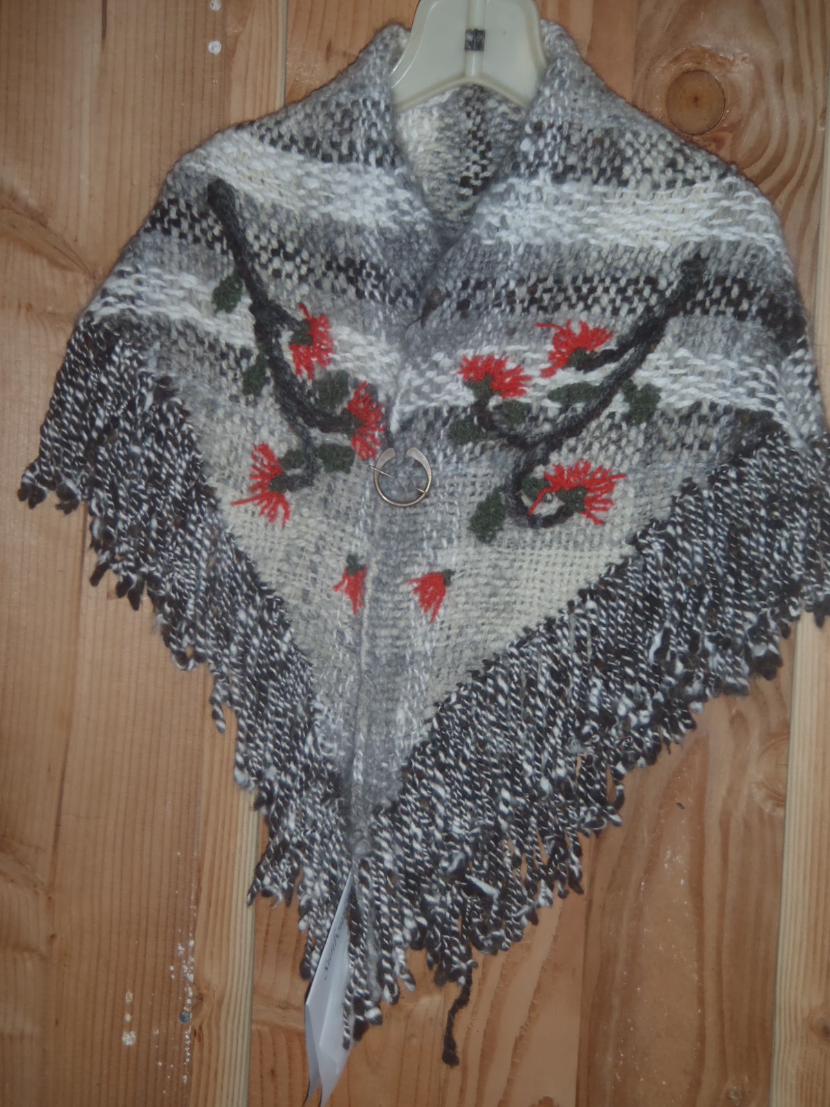 Shawl with embroider ohia blossoms.